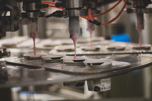 Blackcurrants in Clotted Cream being filled in the factory